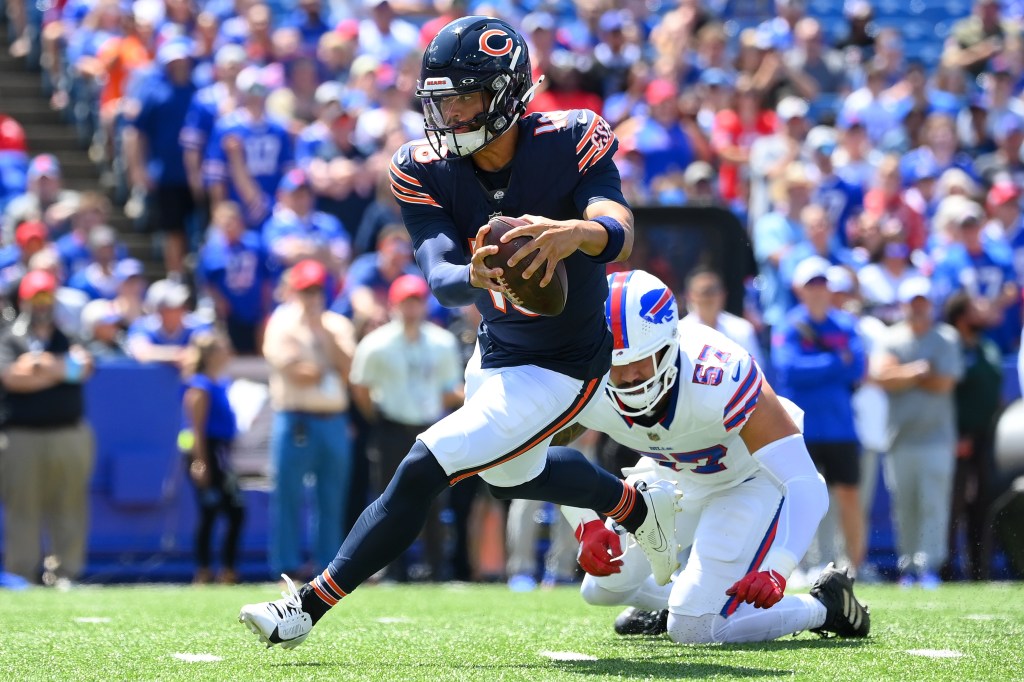 Caleb Williams avoids thr tackle attempt of AJ Epenesa #57 of the Buffalo Bills during the first half of a preseason game at Highmark Stadium on August 10, 2024 in Orchard Park, New York. 